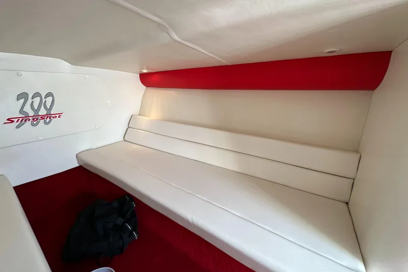 Slide: The Image of 2004 Hustler 388 SLINGSHOT interior with white seating and red accents. - 22