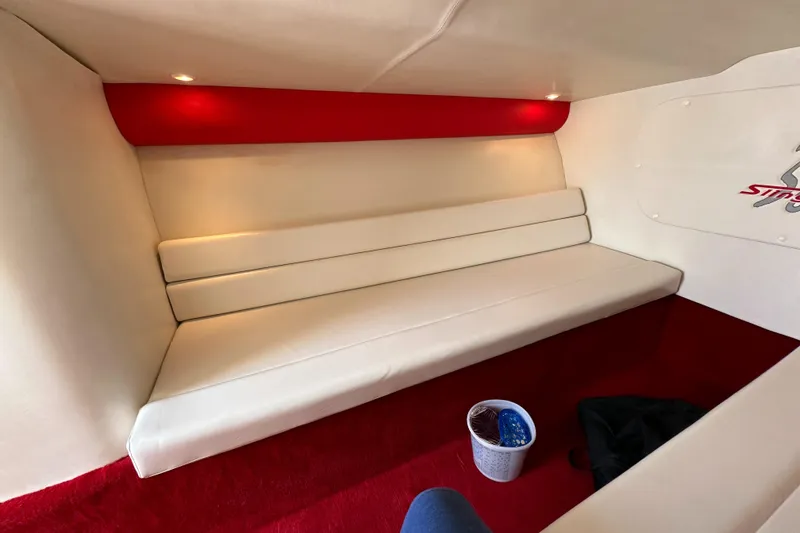 Slide: The Image of 2004 Hustler 388 SLINGSHOT interior with white seating and red accents. - 23