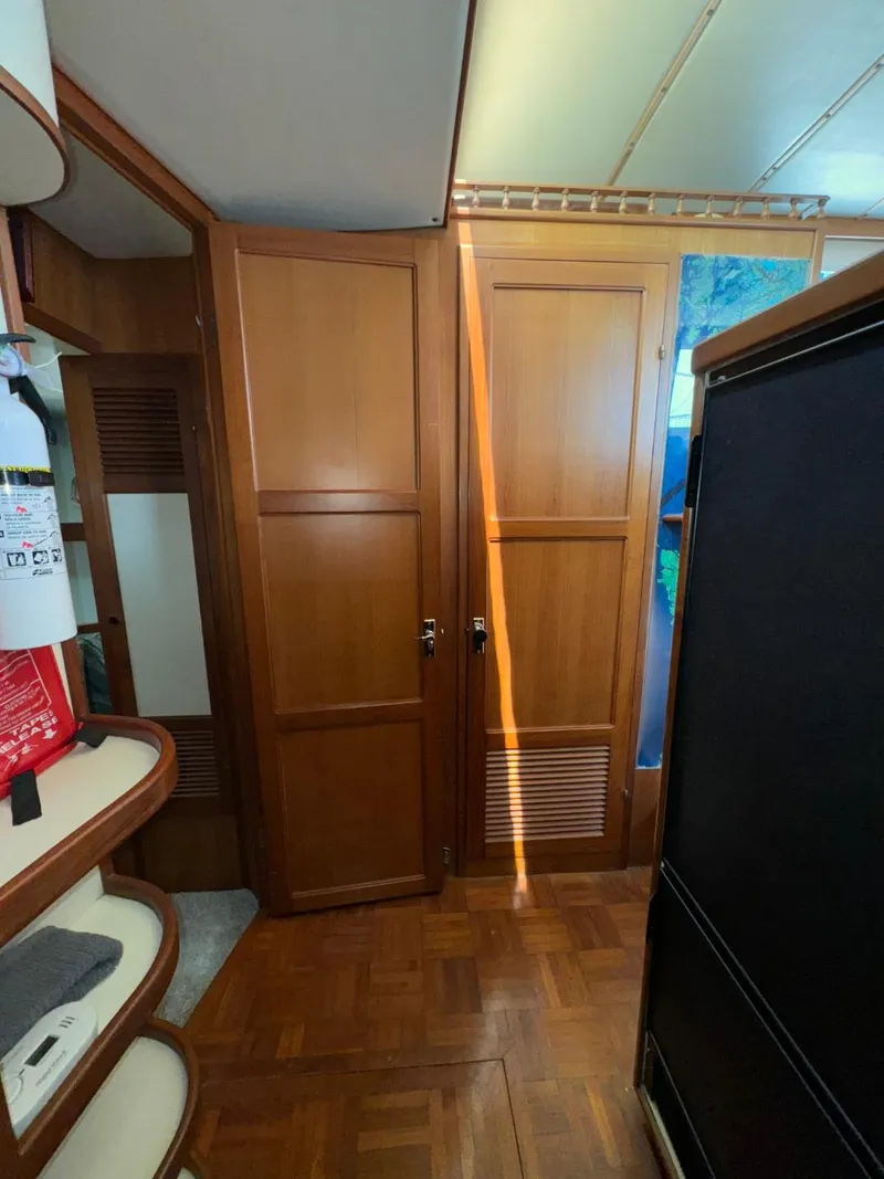 Slide: The Image of 1987 Kadey-Krogen Silhouette interior with wooden cabinets and parquet flooring. - 14