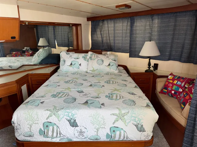 Slide: The Image of Cozy bedroom in 1987 Kadey-Krogen Silhouette yacht with nautical-themed bedding and elegant decor. - 17