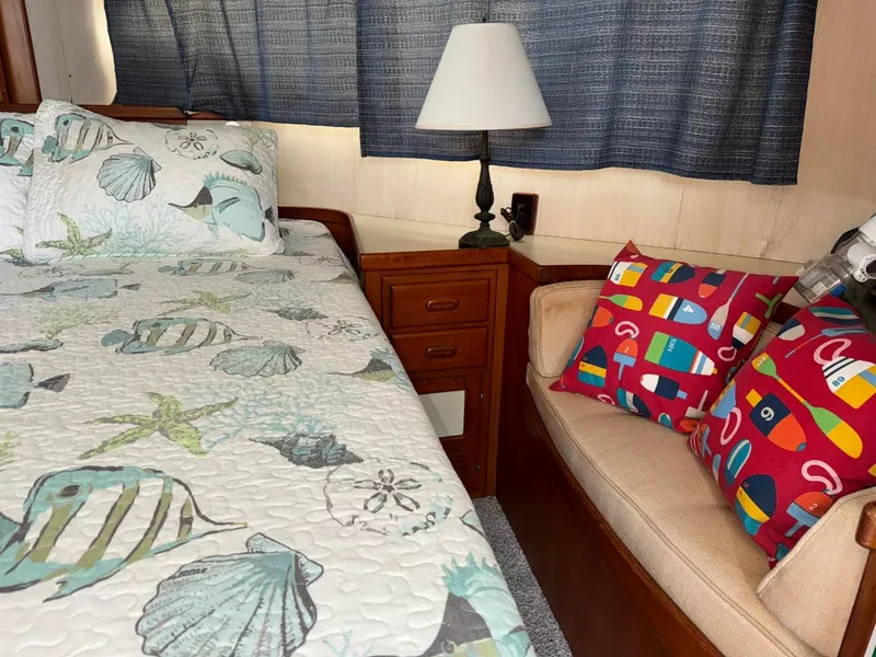 Slide: The Image of Cozy cabin interior of 1987 Kadey-Krogen Silhouette with nautical-themed bedding and colorful cushions. - 18