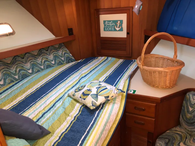 Slide: The Image of Cozy cabin interior of 1987 Kadey-Krogen Silhouette with striped bedding and wicker basket. - 25