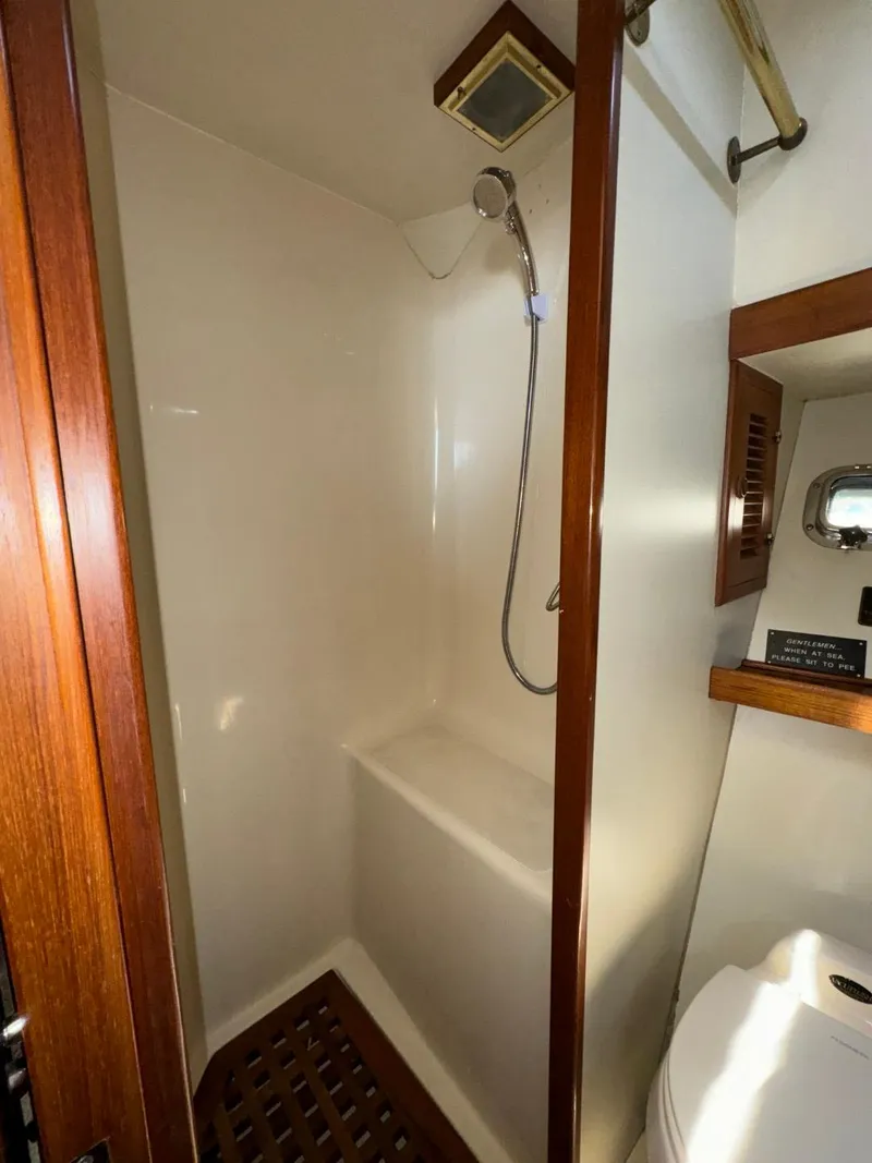 Slide: The Image of 1987 Kadey-Krogen Silhouette yacht bathroom with shower, wooden accents, and compact design. - 27