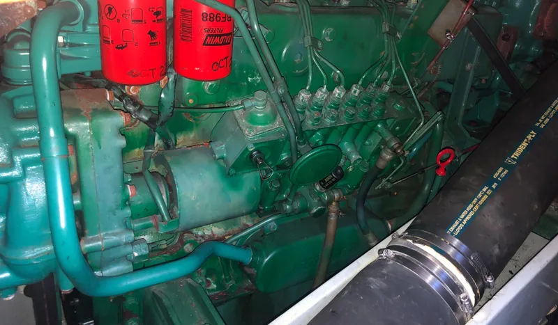 Slide: The Image of Engine compartment of a 1987 Kadey-Krogen Silhouette with visible components and red filters. - 28