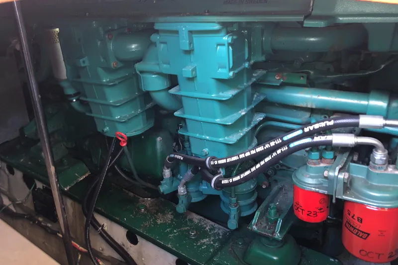 Slide: The Image of Engine of 1987 Kadey-Krogen Silhouette boat, featuring complex mechanical components and hoses. - 29