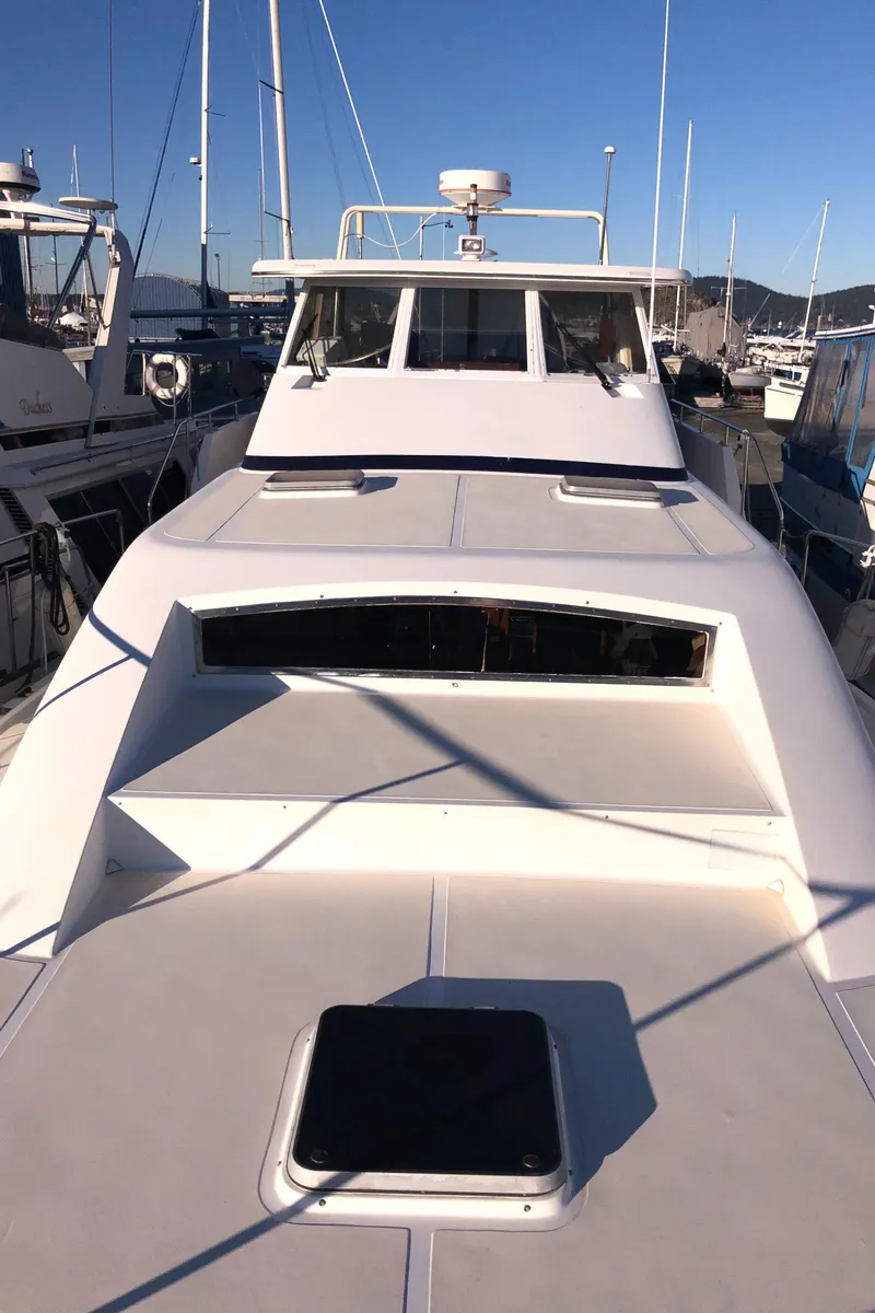 Slide: The Image of 1987 Kadey-Krogen Silhouette yacht docked, showcasing sleek design and spacious deck. - 42