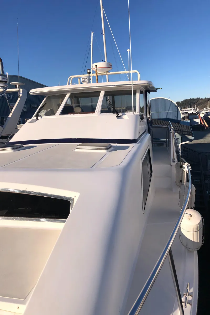 Slide: The Image of 1987 Kadey-Krogen Silhouette yacht docked under clear blue sky. - 43