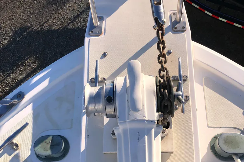 Slide: The Image of Anchor windlass on 1987 Kadey-Krogen Silhouette boat deck, featuring chain and cleats. - 45