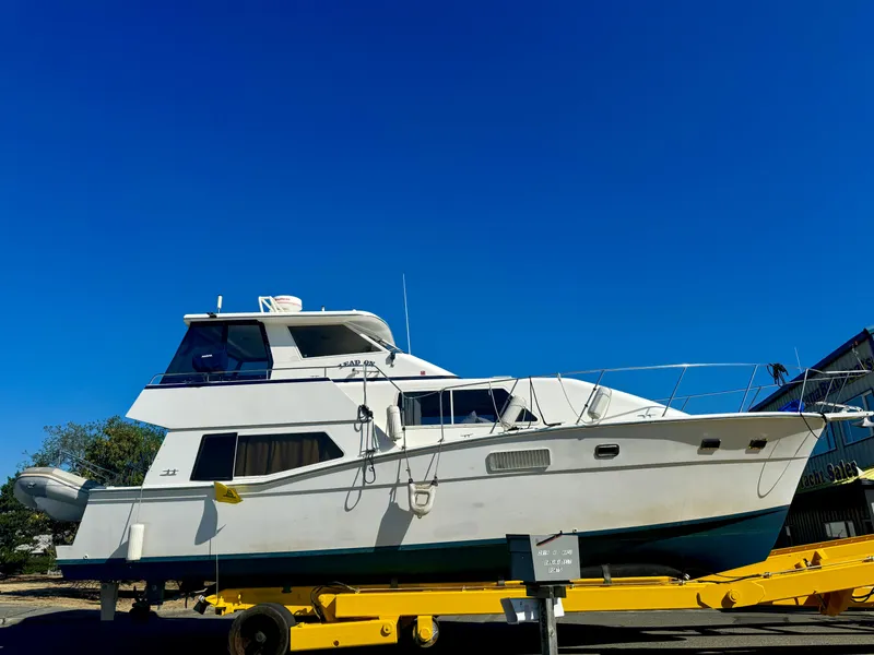 Slide: The Image of 1987 Kadey-Krogen Silhouette yacht on trailer under clear blue sky. - 46