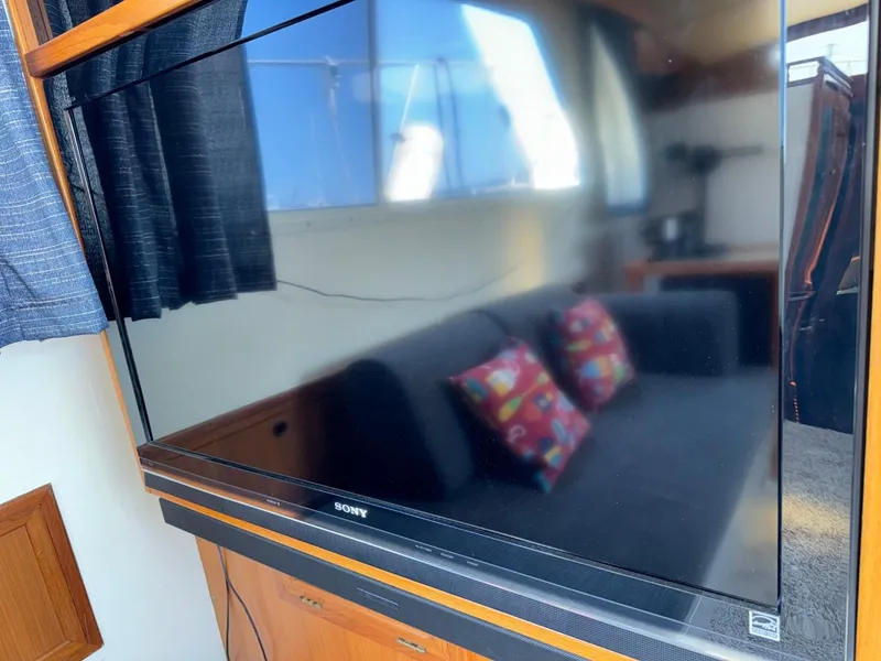 Slide: The Image of 1987 Kadey-Krogen Silhouette interior with Sony TV and colorful cushions on a sofa. - 5