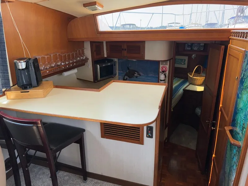 Slide: The Image of 1987 Kadey-Krogen Silhouette yacht interior with kitchen, bar seating, and cozy cabin. - 7
