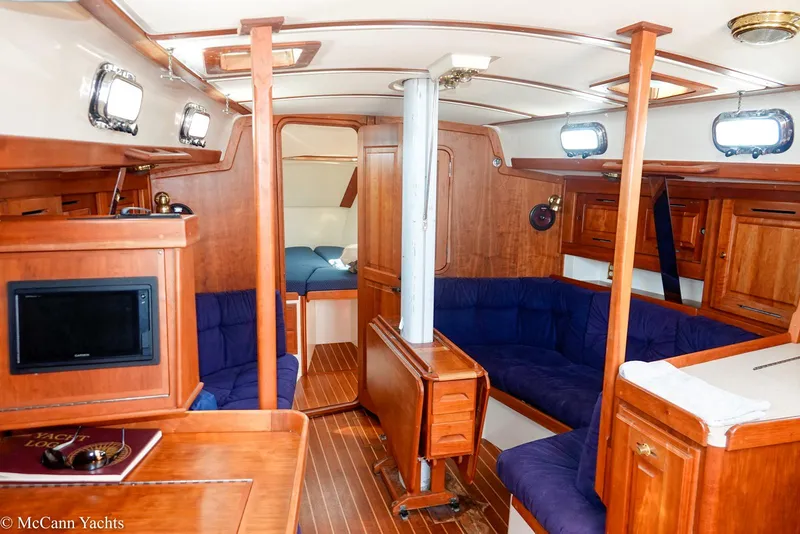 Slide: The Image of Luxurious 2002 Tartan 3700 yacht interior with wooden finish and blue seating. - 10