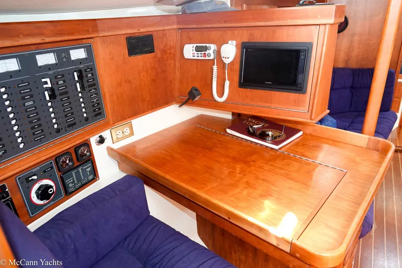 Slide: The Image of Navigation station in 2002 Tartan 3700 yacht with control panels and communication equipment. - 11