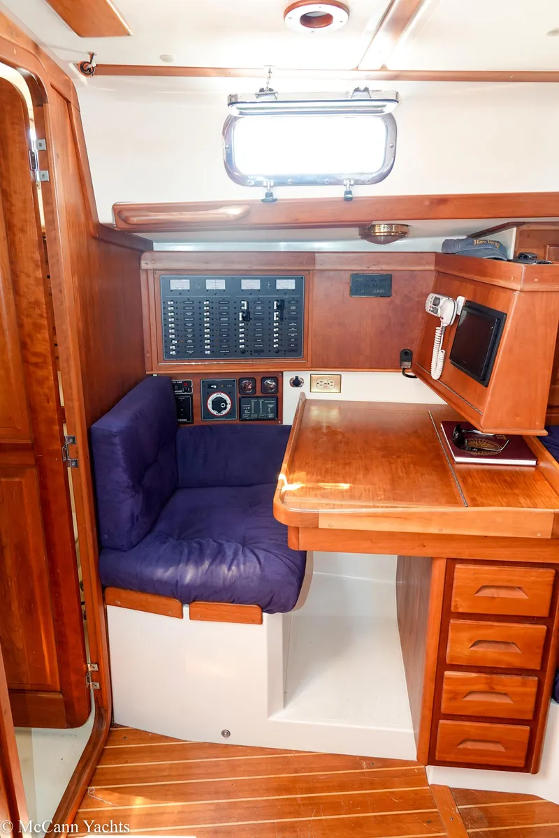 Slide: The Image of Navigation station inside 2002 Tartan 3700 yacht with wood finish and control panel. - 12