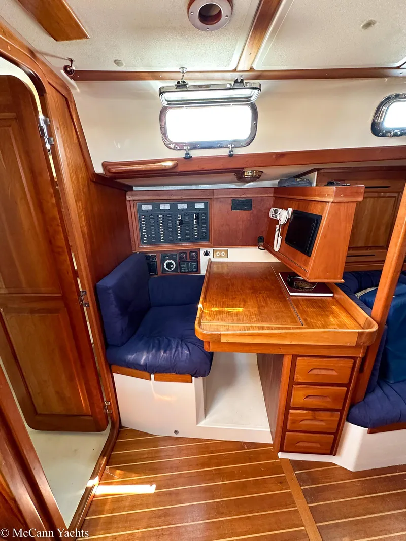 Slide: The Image of Interior of 2002 Tartan 3700 yacht with wooden furnishings and navigation station. - 13