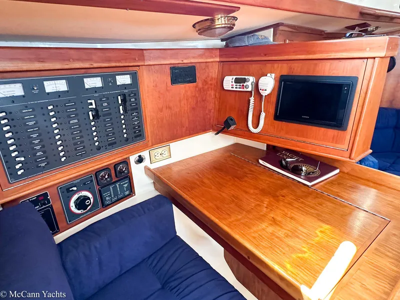 Slide: The Image of Navigation station in a 2002 Tartan 3700 yacht with control panels and communication equipment. - 14