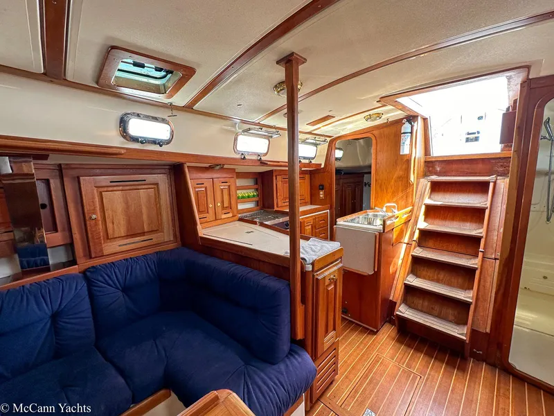 Slide: The Image of Interior of 2002 Tartan 3700 yacht with wooden cabinetry and blue seating. - 16