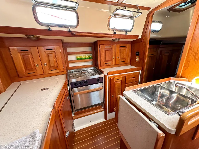 Slide: The Image of Interior of 2002 Tartan 3700 yacht kitchen with wood cabinetry and stainless steel appliances. - 20