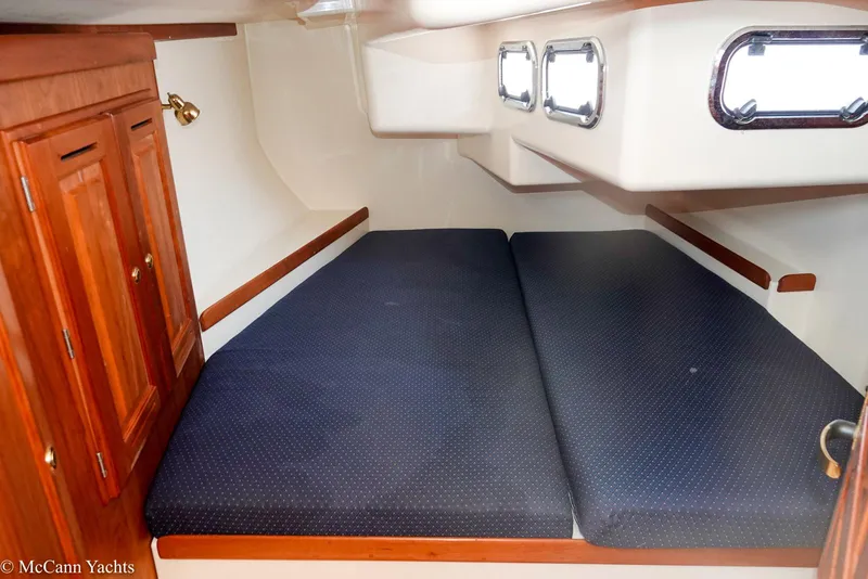 Slide: The Image of Cozy cabin interior of 2002 Tartan 3700 yacht with blue cushions and wooden cabinetry. - 26
