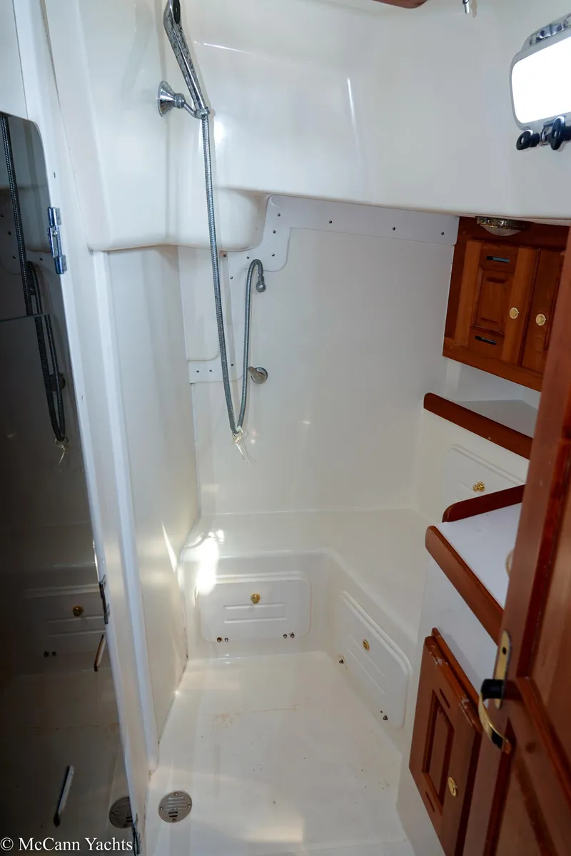 Slide: The Image of Tartan 3700 yacht bathroom, 2002 model, featuring shower and wooden cabinets. - 27