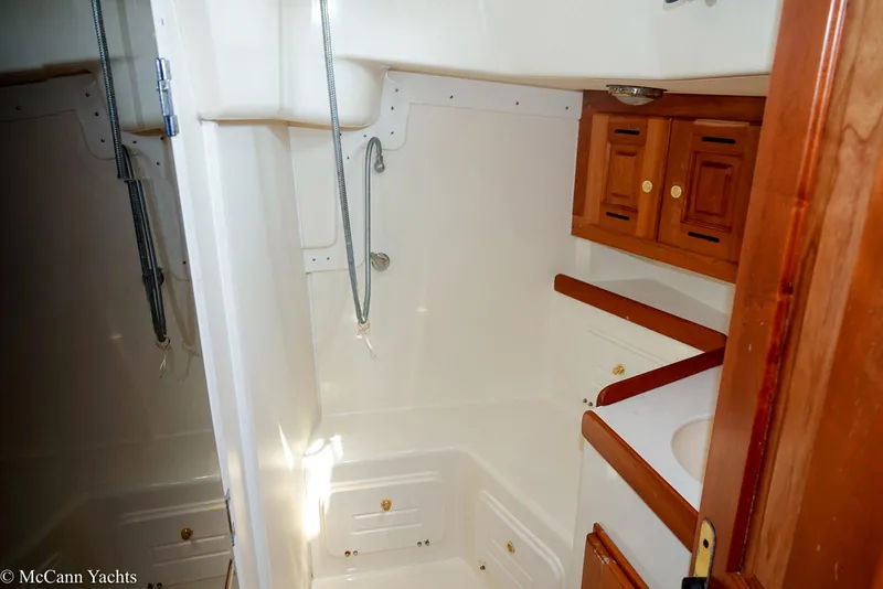 Slide: The Image of Bathroom interior of 2002 Tartan 3700 yacht with wooden cabinets and shower. - 28