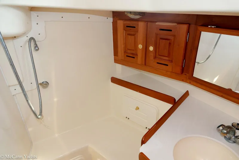 Slide: The Image of Interior of 2002 Tartan 3700 yacht bathroom with wooden cabinets and shower. - 29