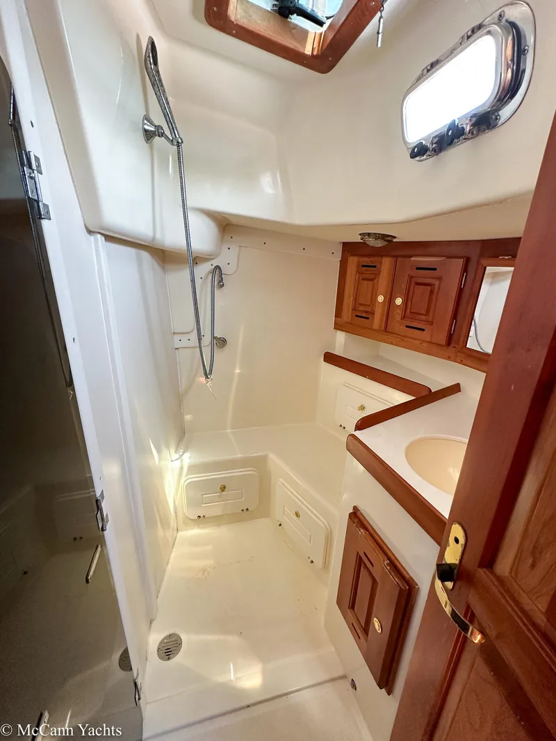 Slide: The Image of Interior of 2002 Tartan 3700 yacht bathroom with shower and wooden cabinets. - 30