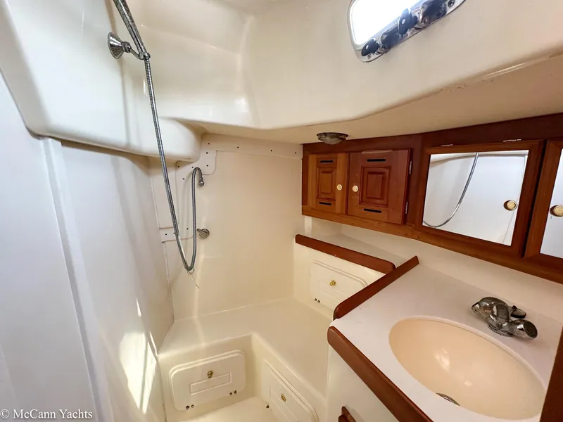 Slide: The Image of Bathroom interior of 2002 Tartan 3700 yacht with shower and wooden cabinets. - 31