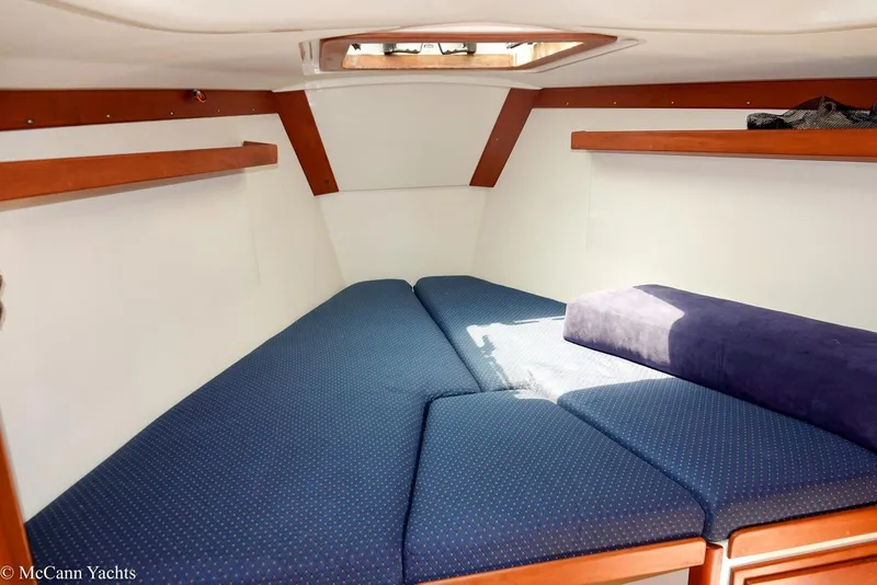 Slide: The Image of Cozy cabin interior of 2002 Tartan 3700 yacht with blue cushions and wooden accents. - 33