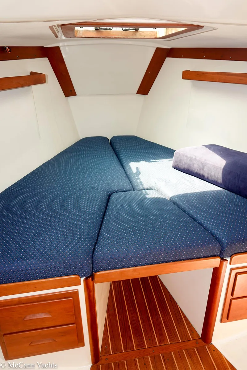 Slide: The Image of Cozy cabin interior of 2002 Tartan 3700 sailboat with blue cushions and wooden accents. - 35