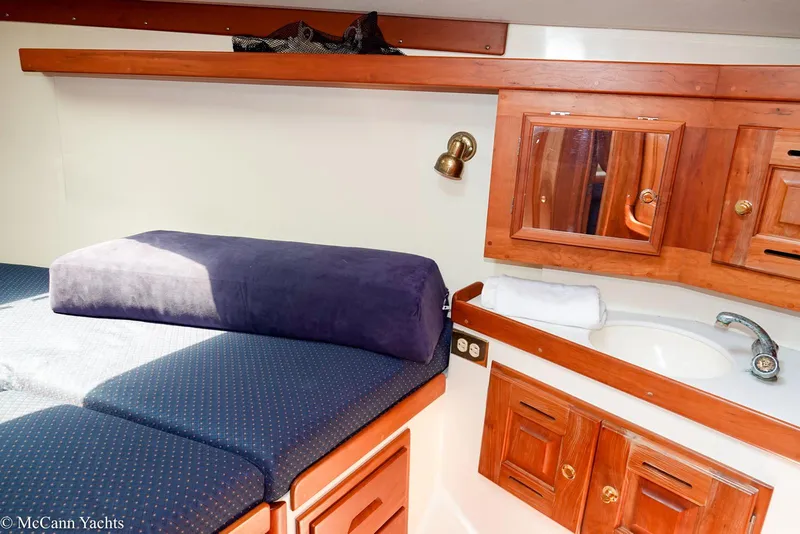 Slide: The Image of Cozy cabin interior of 2002 Tartan 3700 yacht with bed, sink, and wooden cabinetry. - 36