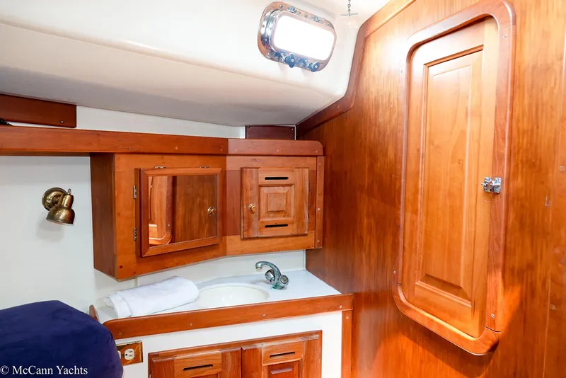 Slide: The Image of Interior of 2002 Tartan 3700 yacht featuring wooden cabinetry and sink. - 38