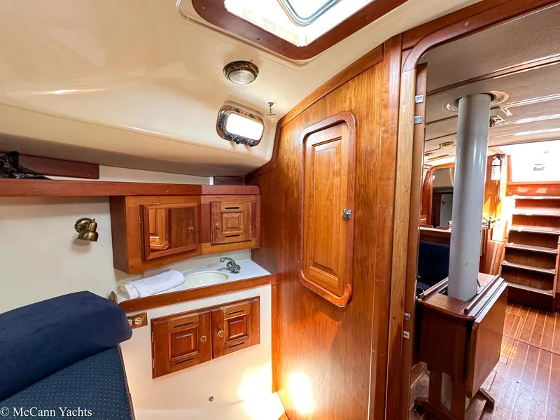 Slide: The Image of Interior of 2002 Tartan 3700 yacht with wooden cabinetry and cozy seating area. - 39
