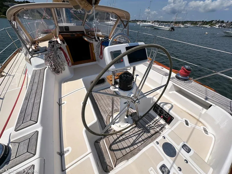 Slide: The Image of Cockpit of 2002 Tartan 3700 sailboat with steering wheel and navigation equipment. - 4