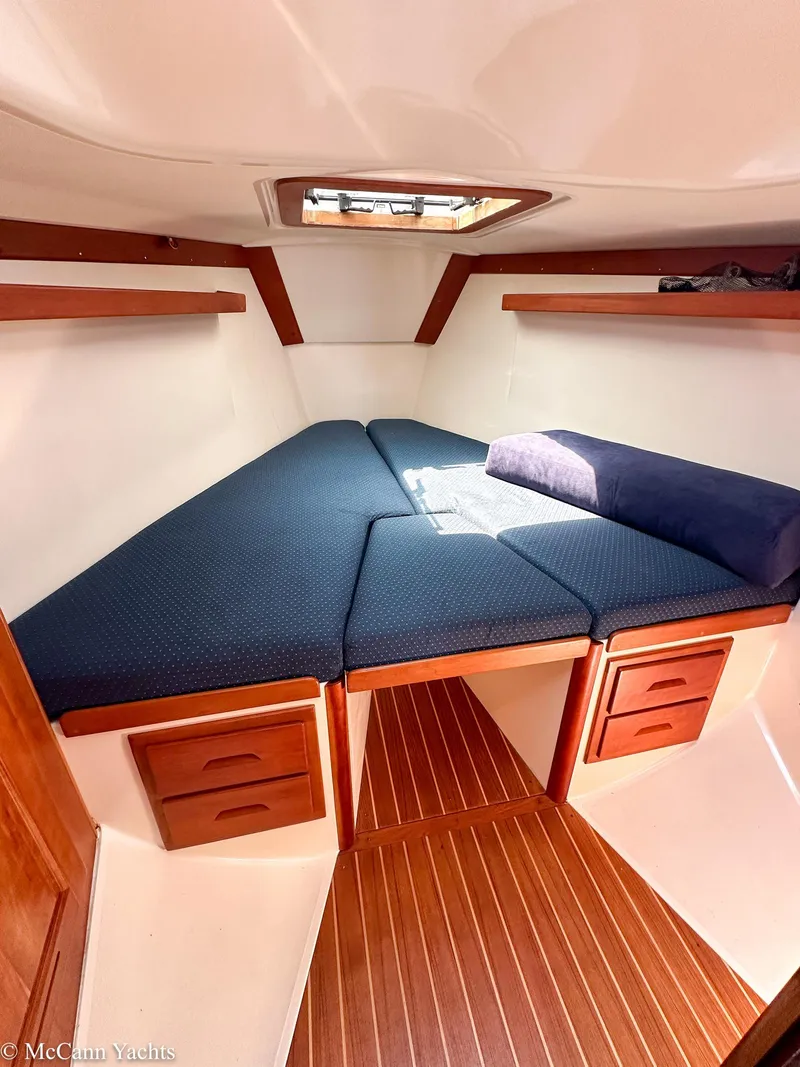Slide: The Image of Cozy cabin interior of 2002 Tartan 3700 yacht with wooden accents and comfortable bedding. - 41