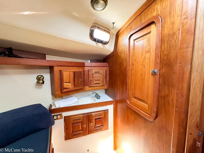 Slide: The Image of Interior of 2002 Tartan 3700 yacht with wooden cabinetry and compact sink area. - 42