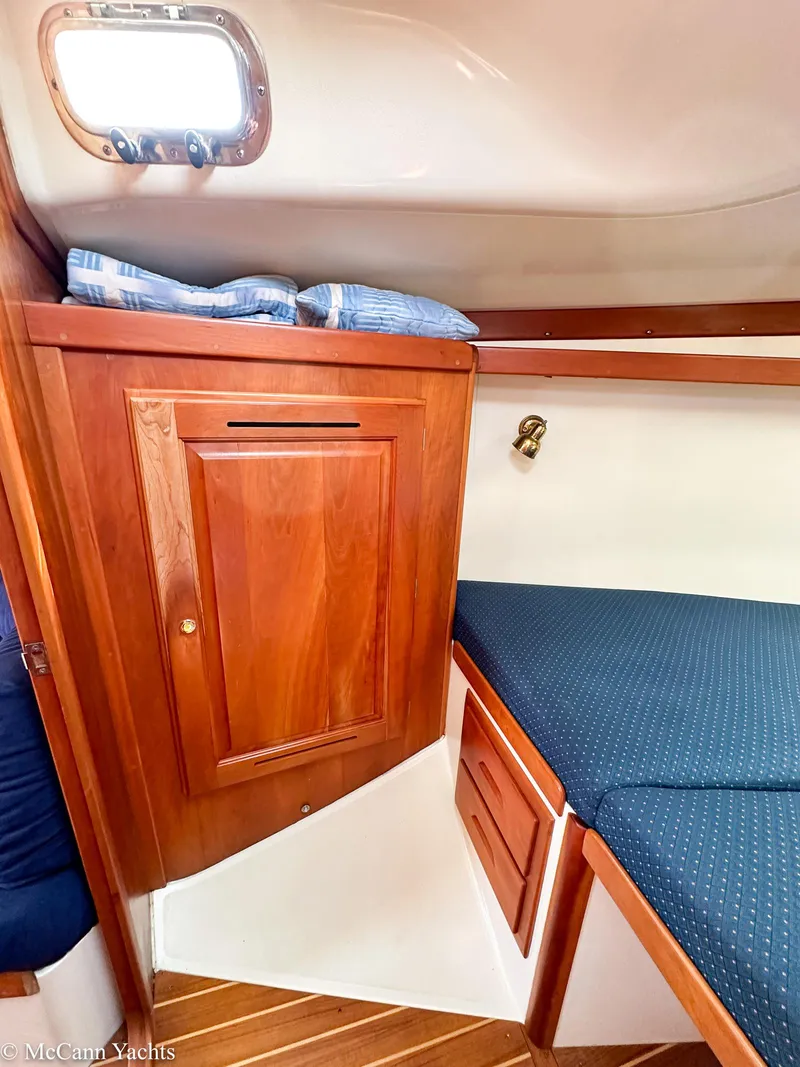 Slide: The Image of Cozy cabin interior of 2002 Tartan 3700 yacht with wooden cabinetry and blue bedding. - 43