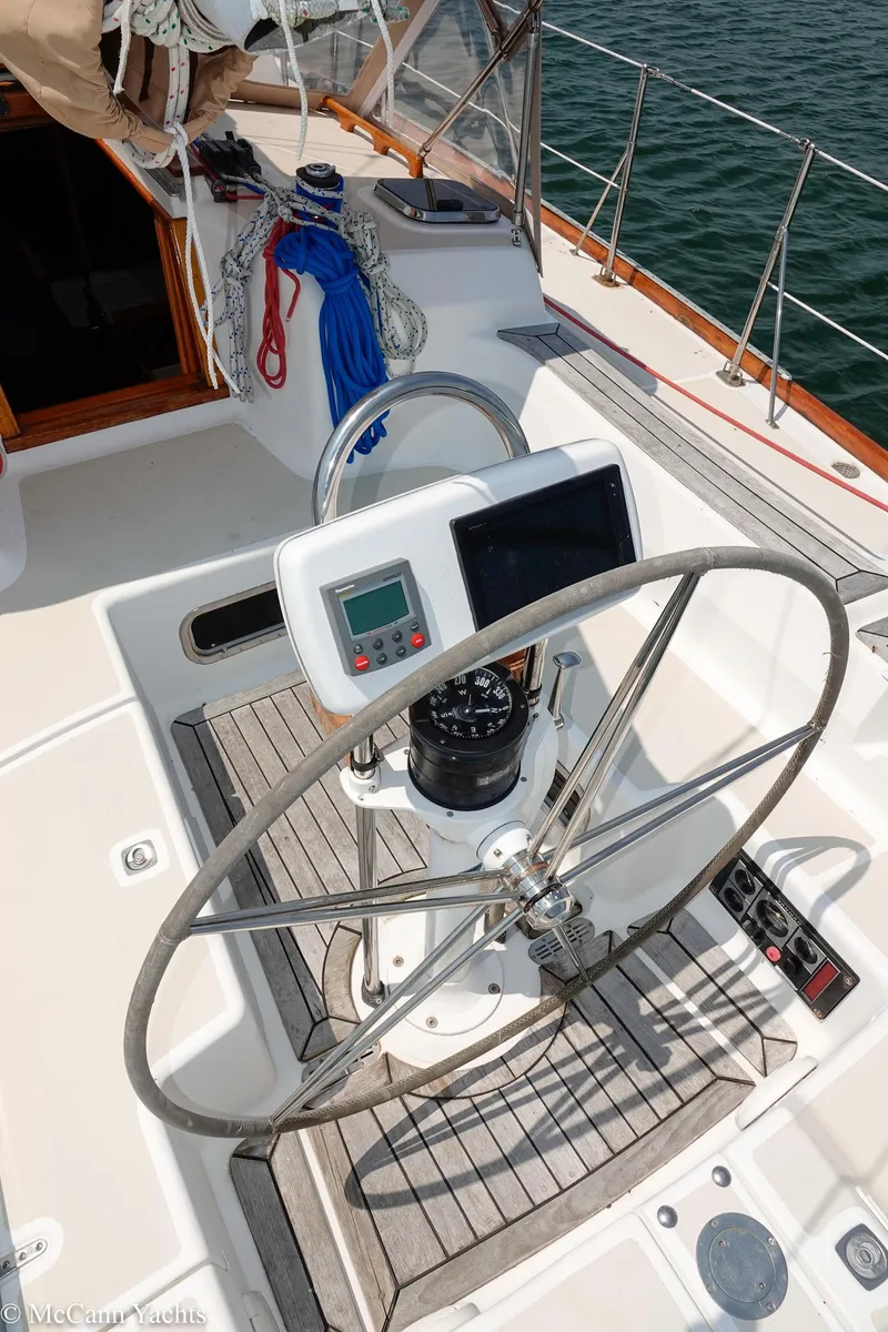 Slide: The Image of Steering wheel and navigation equipment on a 2002 Tartan 3700 sailboat deck. - 46