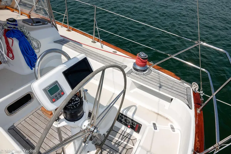 Slide: The Image of Cockpit of 2002 Tartan 3700 sailboat with steering wheel and navigation equipment. - 47