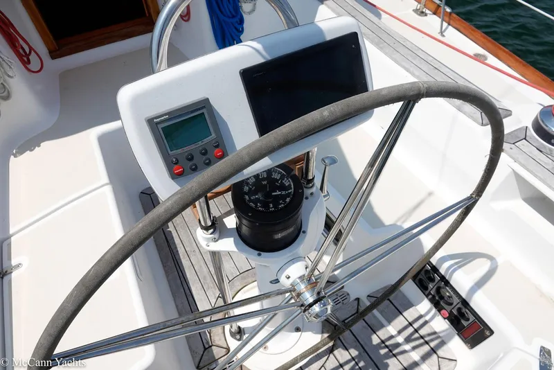 Slide: The Image of Helm of 2002 Tartan 3700 sailboat with navigation instruments and steering wheel. - 49