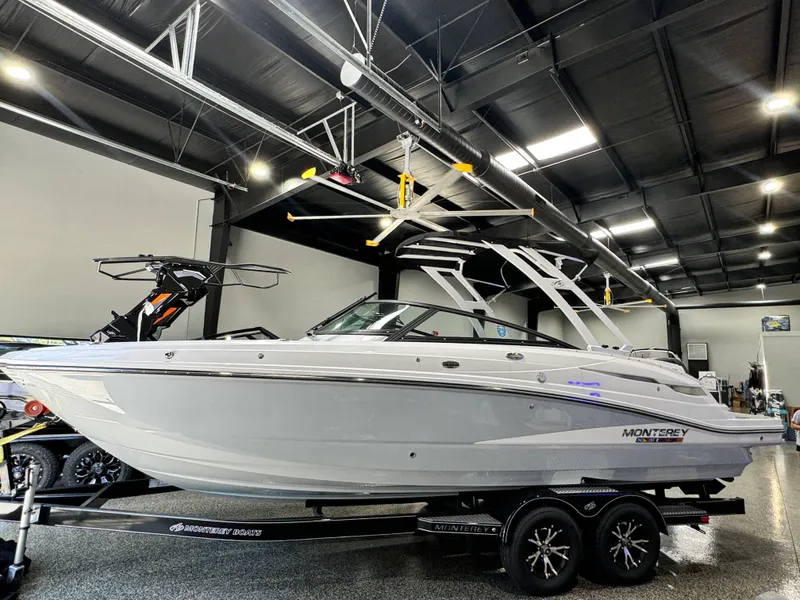 Slide: The Image of 2024 Monterey M6 boat in showroom, sleek design, on trailer. - 1