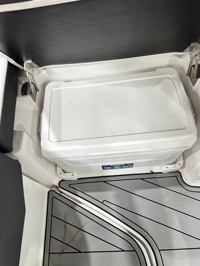 Slide: The Image of 2024 Monterey M6 boat interior with built-in cooler and sleek flooring design. - 12