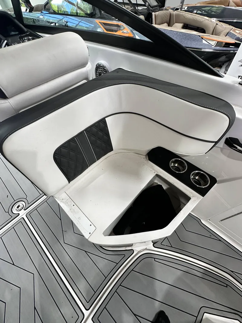 Slide: The Image of 2024 Monterey M6 boat interior with white seating and cup holders. - 14