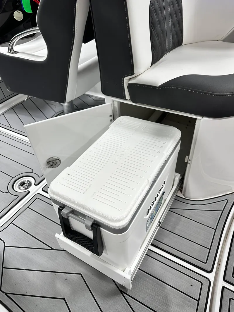 Slide: The Image of 2024 Monterey M6 boat interior with built-in cooler storage under seat. - 16