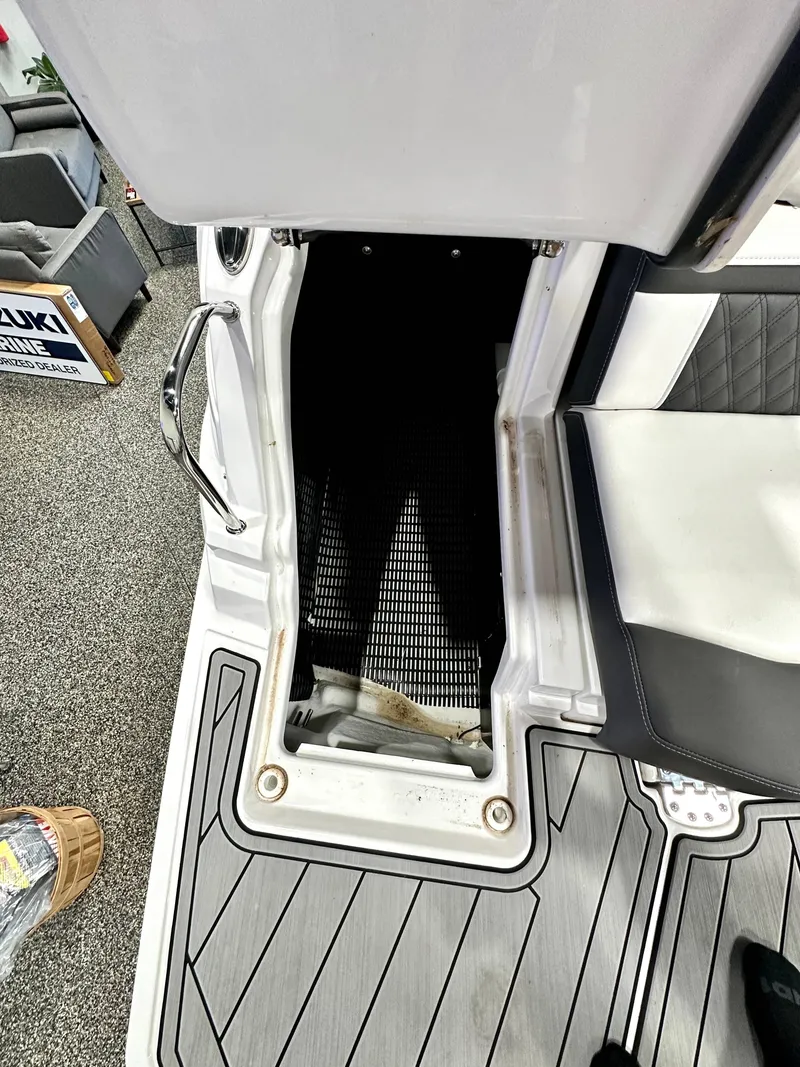 Slide: The Image of 2024 Monterey M6 boat interior with open storage compartment and cushioned seating. - 17