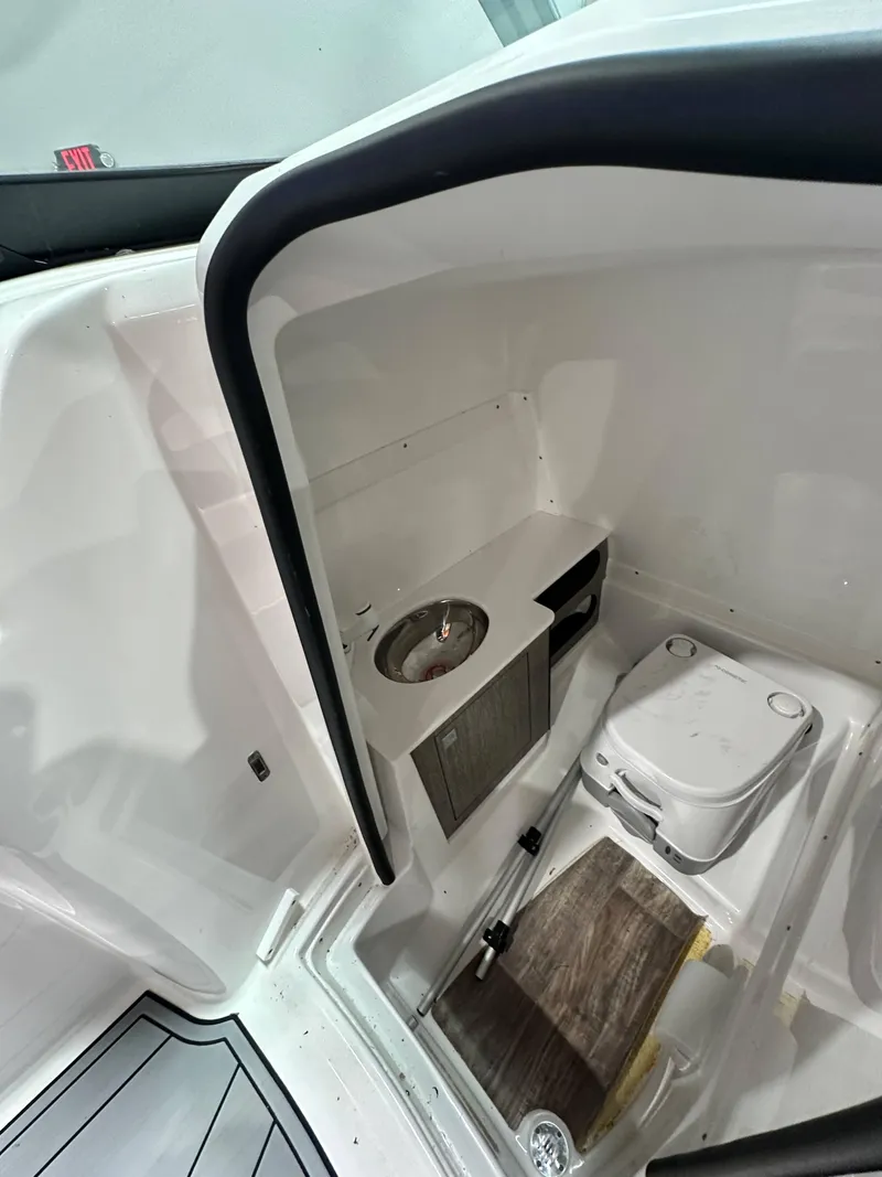 Slide: The Image of 2024 Monterey M6 boat interior with compact bathroom and sink. - 18