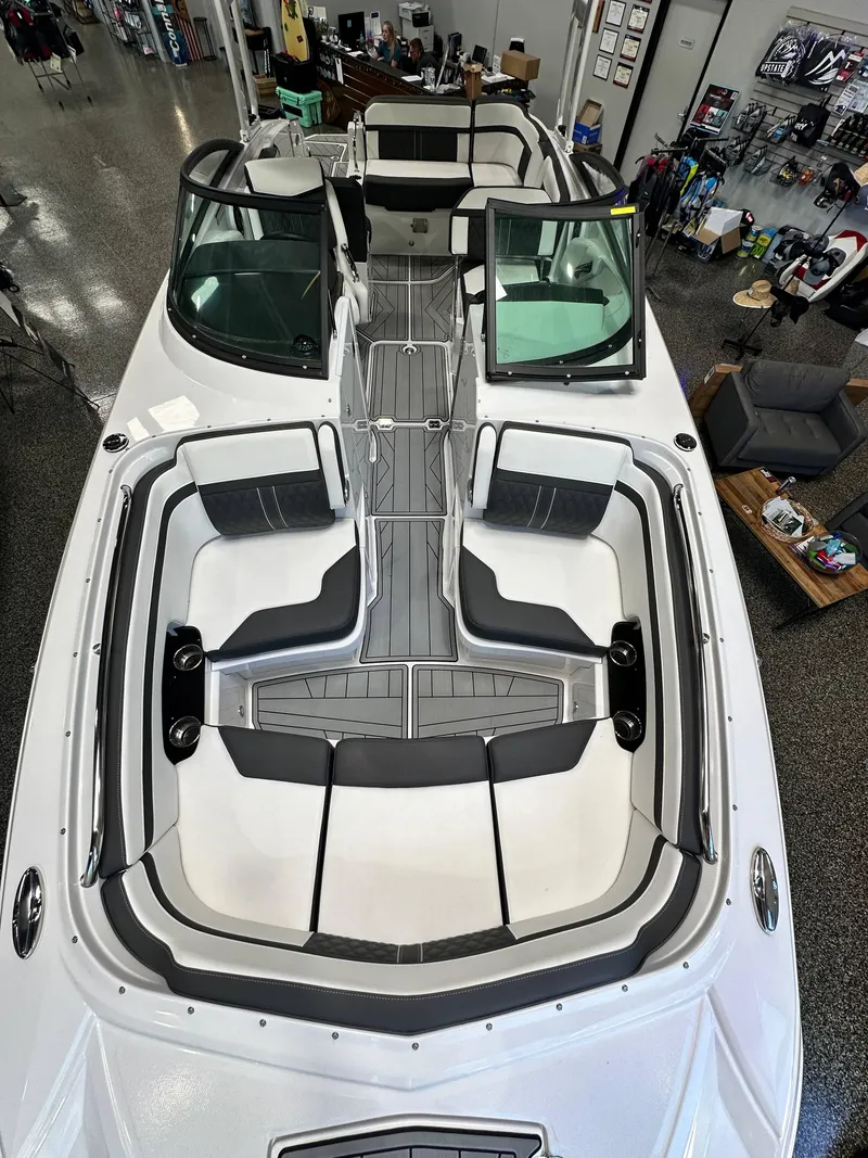 Slide: The Image of 2024 Monterey M6 boat interior with sleek seating and modern design in showroom. - 5