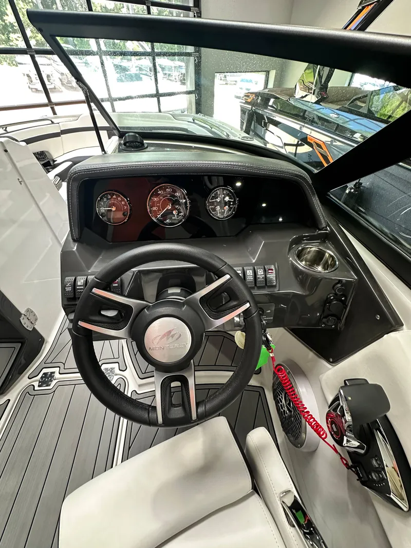 Slide: The Image of 2024 Monterey M6 boat dashboard with steering wheel and control panel. - 7