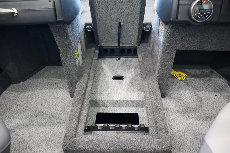 Slide: The Image of 2025 Crestliner 1850 Super Hawk WT JS interior with storage compartment and carpeted flooring. - 11