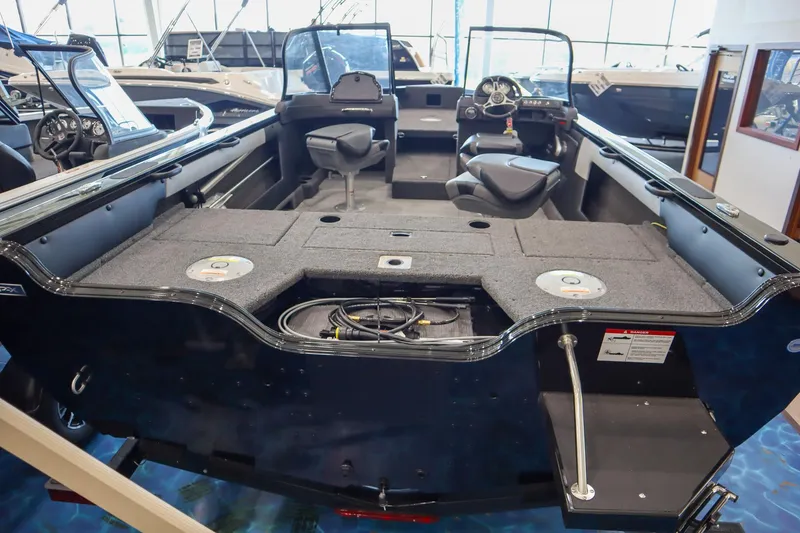 Slide: The Image of 2025 Crestliner 1850 Super Hawk WT JS boat interior with seating and steering console. - 3